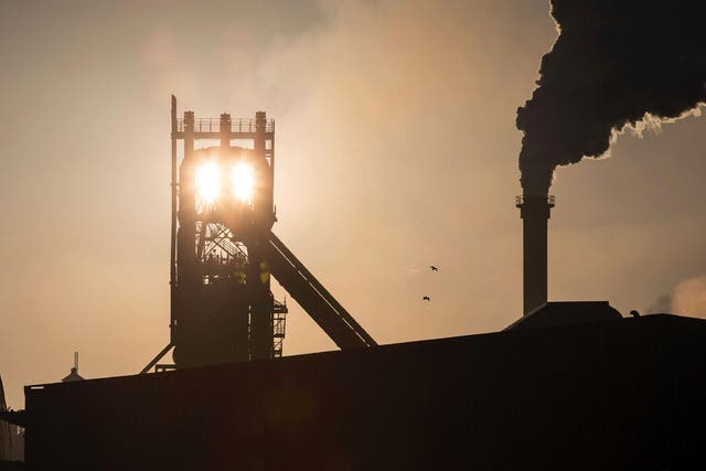 The sun rises above Tata Steel's blast furnaces at their Scunthorpe Plant in north east England