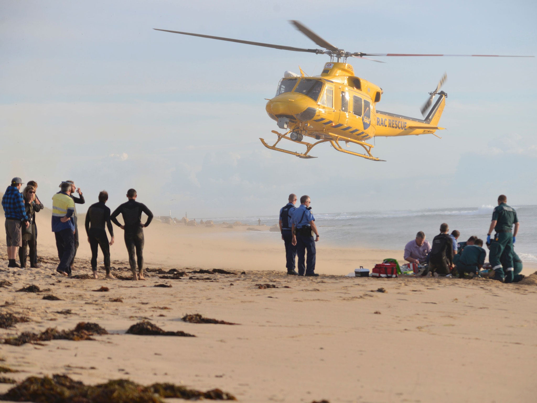 A photo taken on 31 May, 2016, shows a rescue helicopter arriving to transport a critically injured surfer