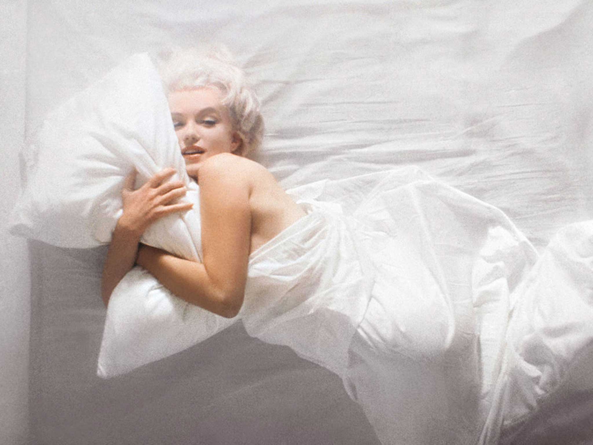 Douglas Kirkland's 1961 photograph shows a whimsical Monroe posing in bed