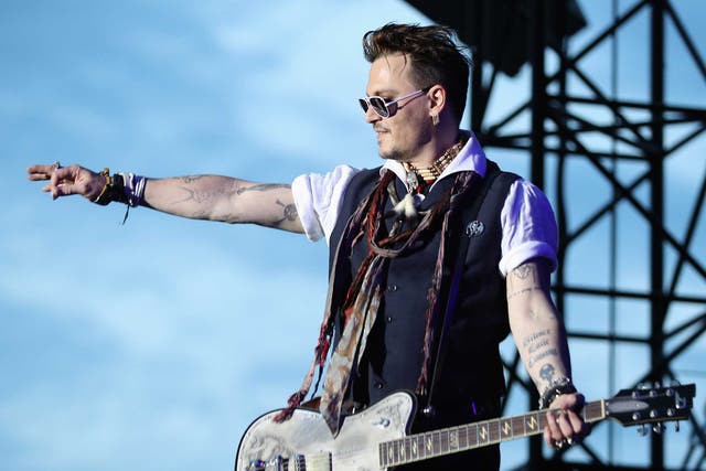Johnny Depp performing with his band in Germany