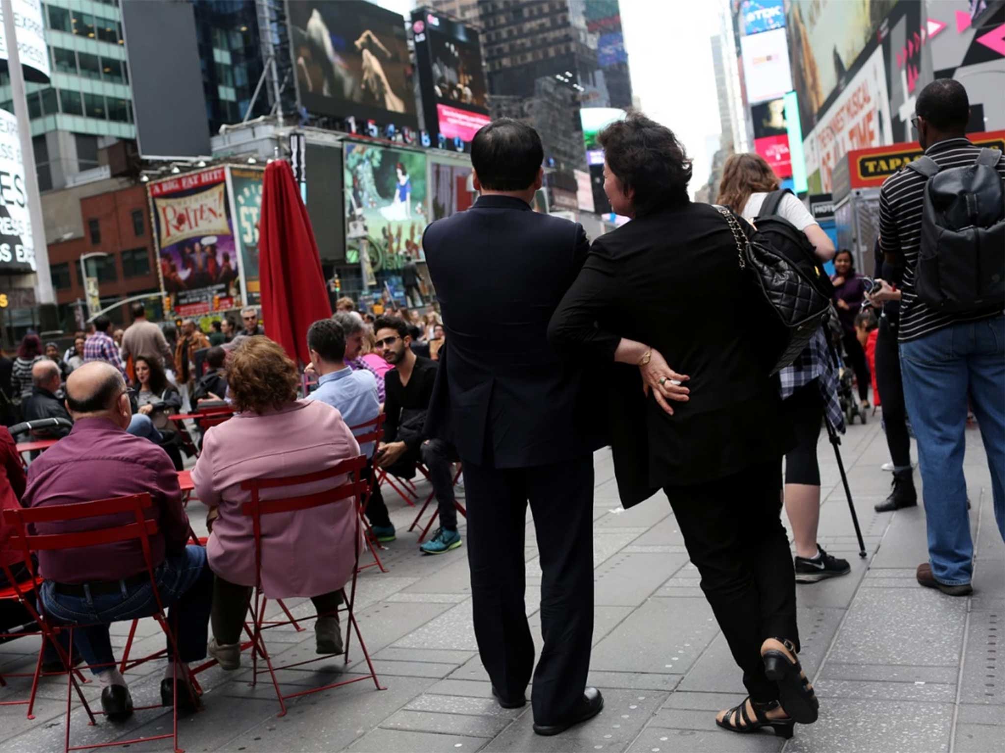 Kim Jong Un’s maternal aunt and her husband, known in North Korea as Ko Yong Suk and Ri Gang, pose for a portrait in New York’s Times Square. They have been living in the United States since 1998, and run a dry-cleaning store