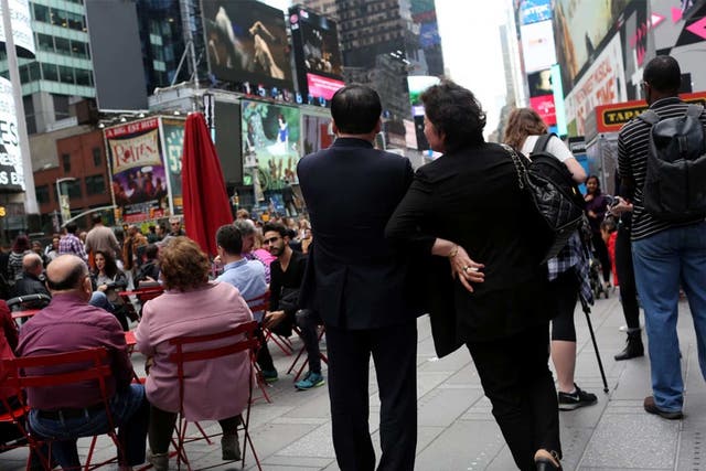 Kim Jong Un’s maternal aunt and her husband, known in North Korea as Ko Yong Suk and Ri Gang, pose for a portrait in New York’s Times Square. They have been living in the United States since 1998, and run a dry-cleaning store