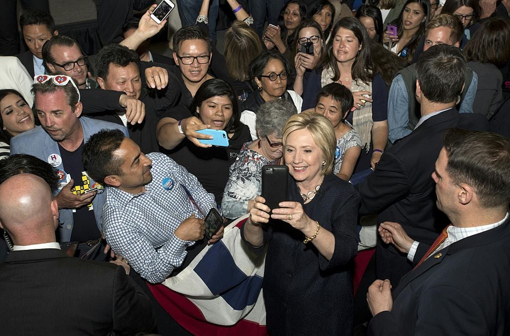 Millennial Hillary Clinton takes a selfie with supporters.
