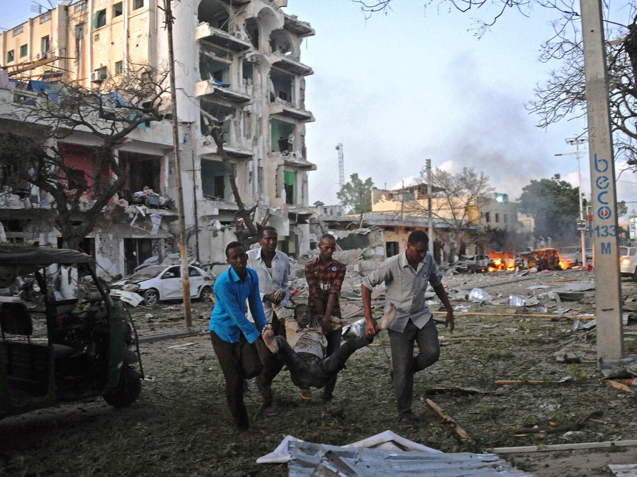 A victim of a terror attack is carried away from the Ambassador Hotel, after a car bomb exploded on June 1
