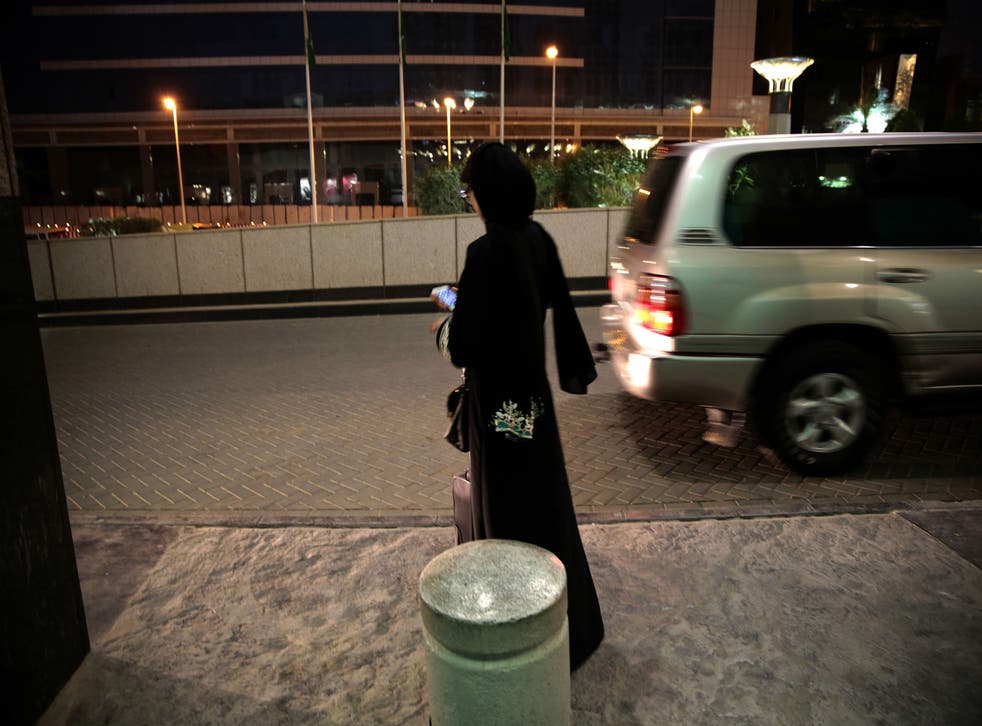 A woman waits for an Uber in Riyadh, the capital of Saudi Arabia, where women are forbidden from driving themselves