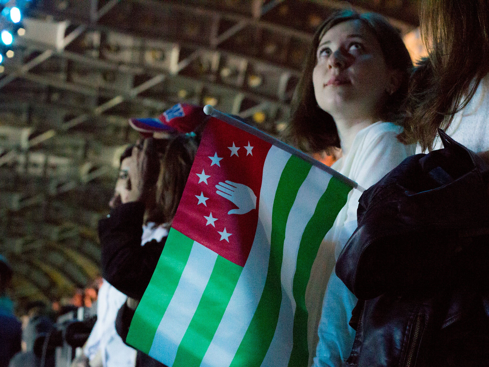 Fans at the start of the tournament holding the flag of Abkhazia