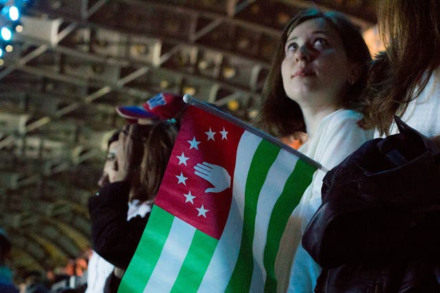 Fans at the start of the tournament holding the flag of Abkhazia