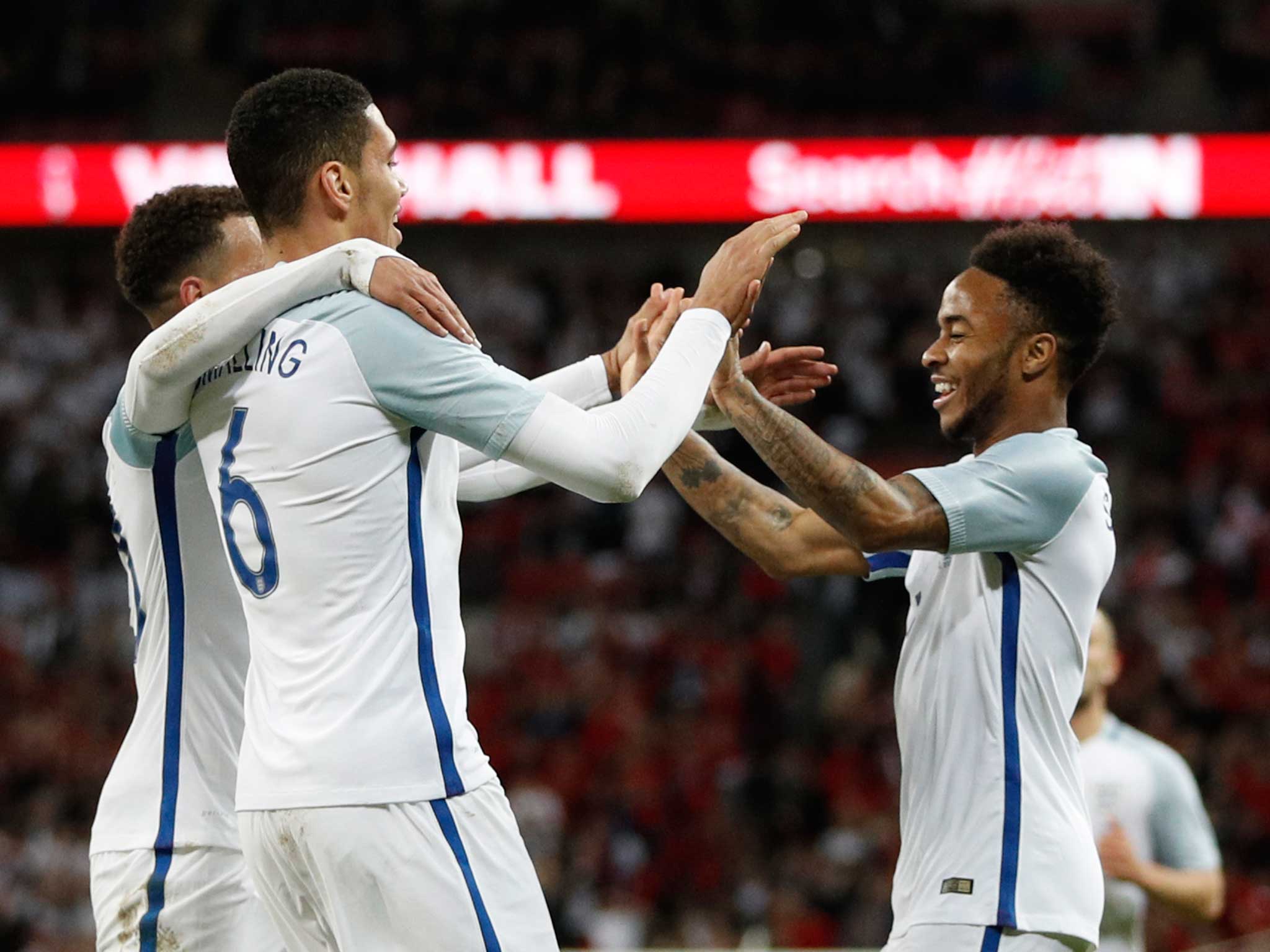 Chris Smalling is congratulated by his England team-mates after scoring a late winner