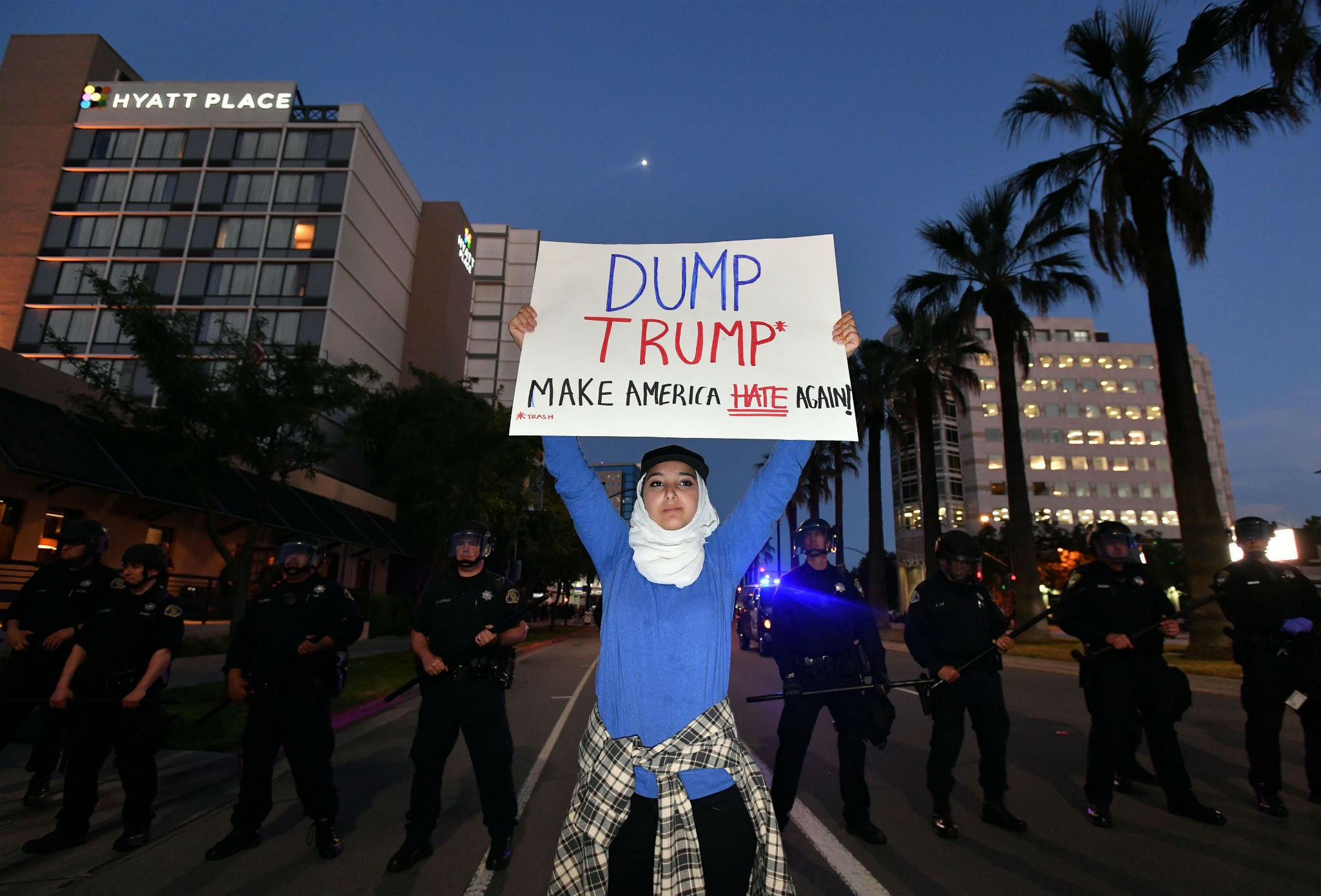 A protester holds up a placard outside a Donald Trump rally in San Jose, California on 2 June