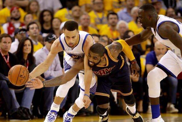 Steph Curry competes for the ball with Kyrie Irving during match one of the NBA Finals