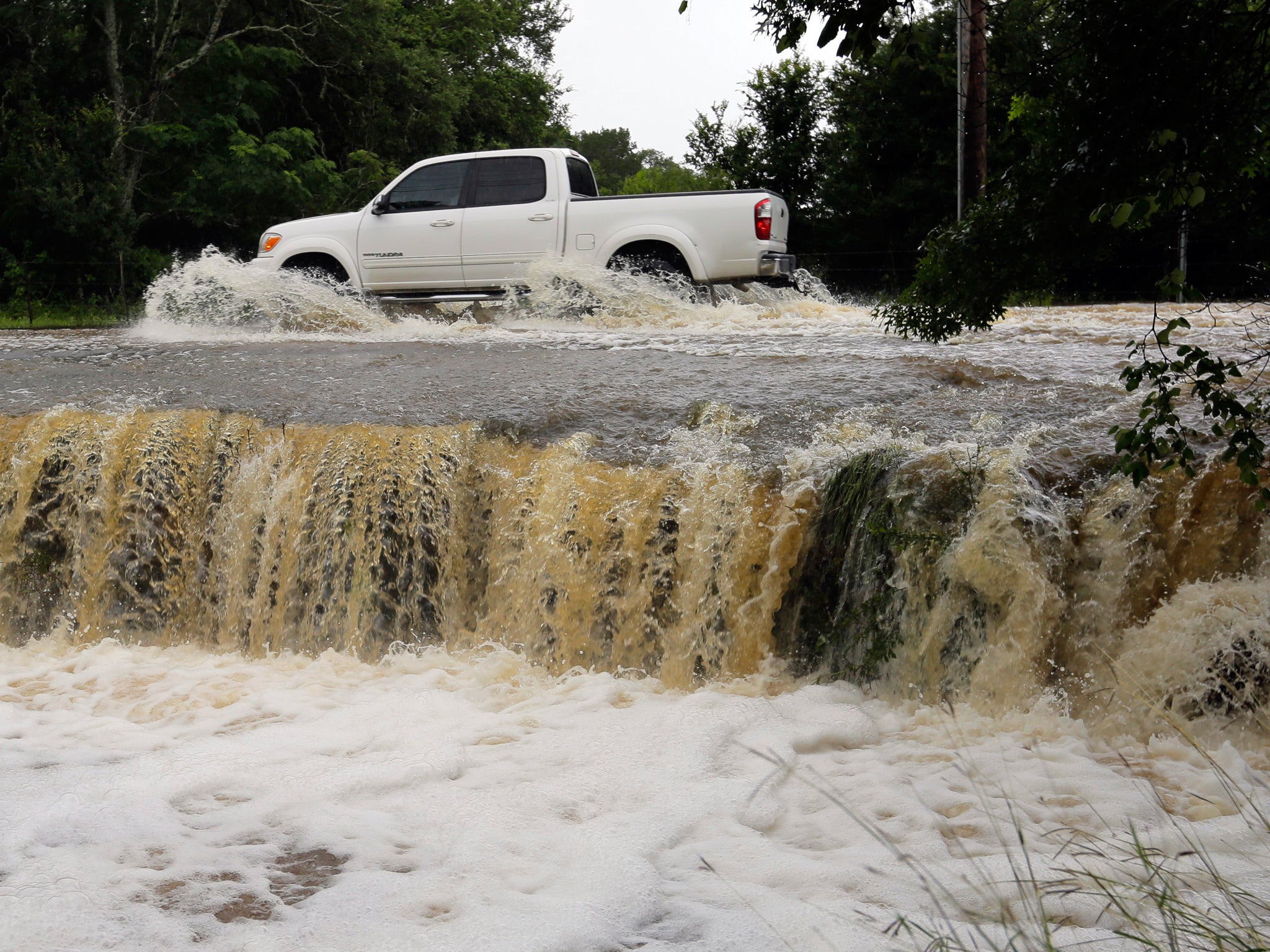 A Texas pickup truck passes through a low-water crossing AP