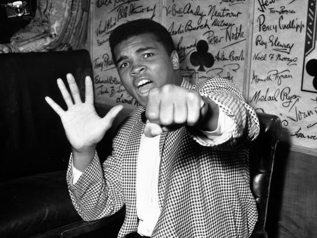 Muhammad Ali in 1963, holding up five fingers to predict how many rounds it will take him to beat British boxer Henry Cooper