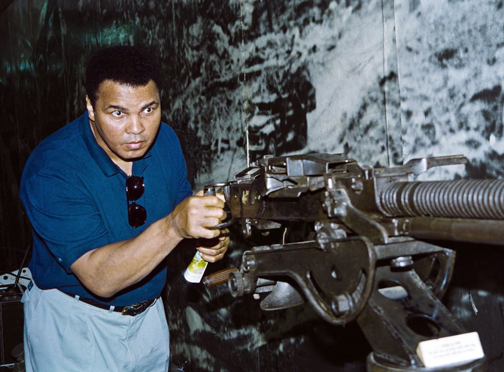 Muhammad Ali with an anti-aircraft gun used by North Vietnamese army during the Vietnam War during a visit to the Hanoi Army Museum in Hanoi, Vietnam on May 12, 1994.