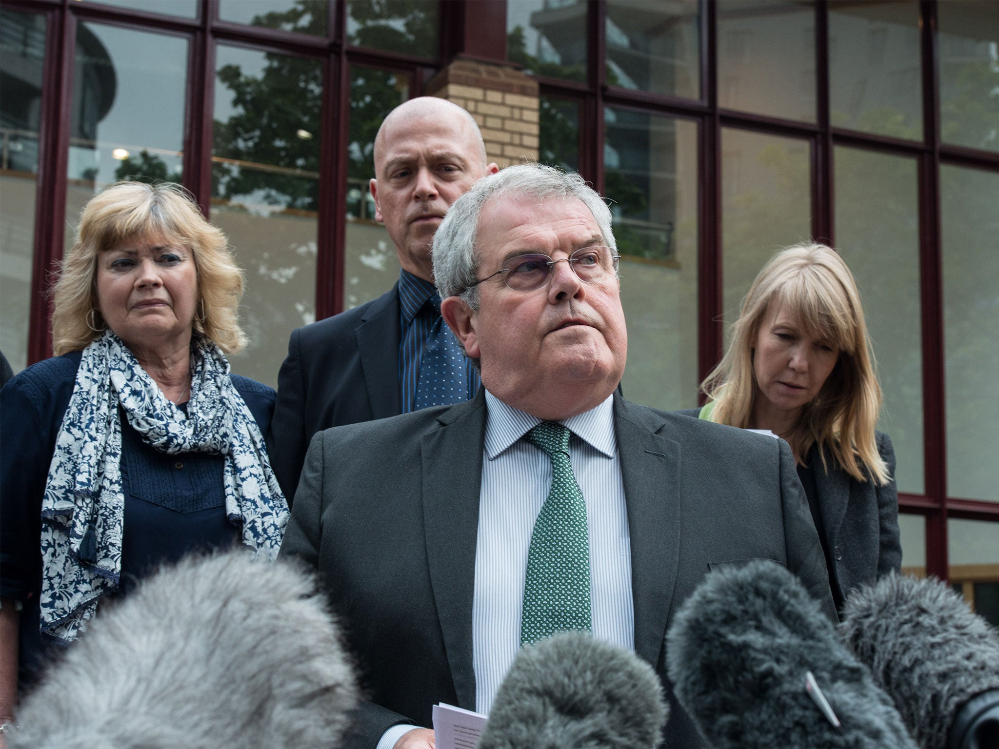 Father of Private Cheryl James, Des James, speaks to members of the press with his wife Doreen James (with scarf) and other family members standing behind