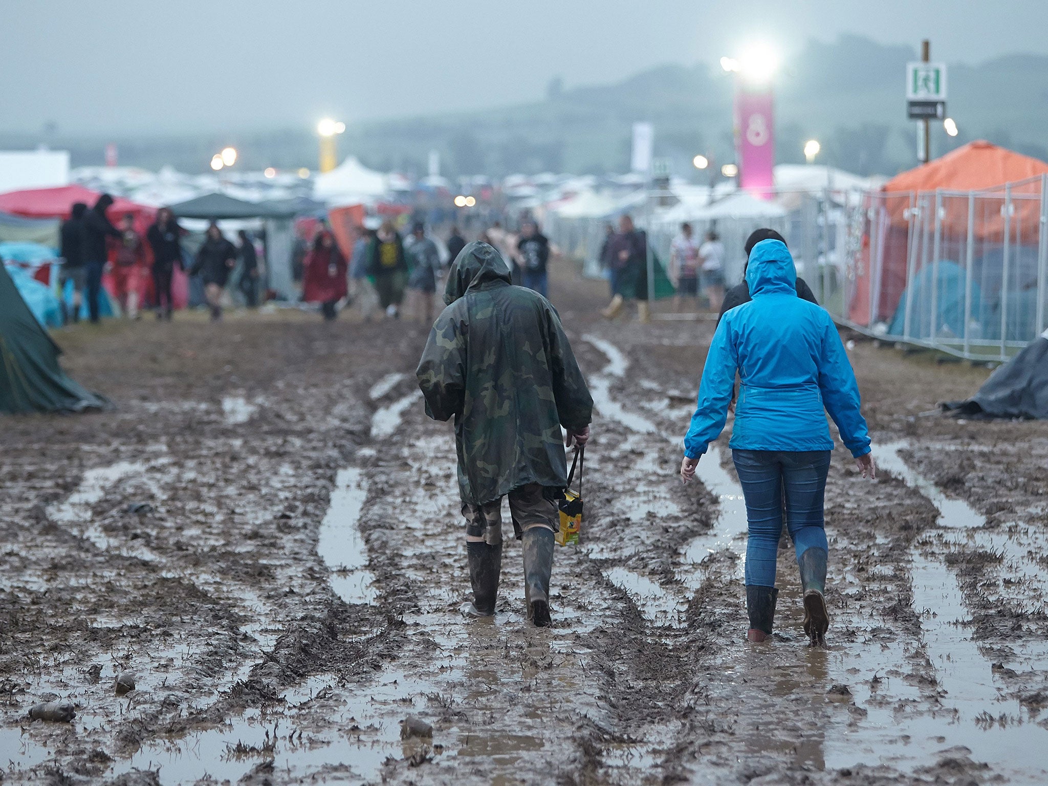 Fans walk on in the mud after the venue of the festival 'Rock am Ring' was hit by a storm in Mendig, Germany, 03 June 2016
