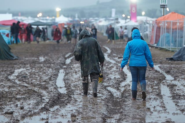 Fans walk on in the mud after the venue of the festival 'Rock am Ring' was hit by a storm in Mendig, Germany, 03 June 2016