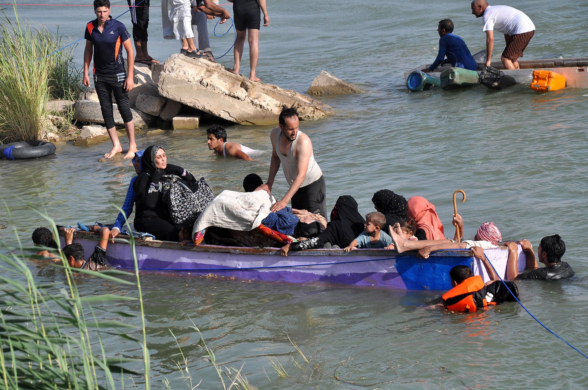 Heading to safe haven during fighting between Iraqi security forces and Isis