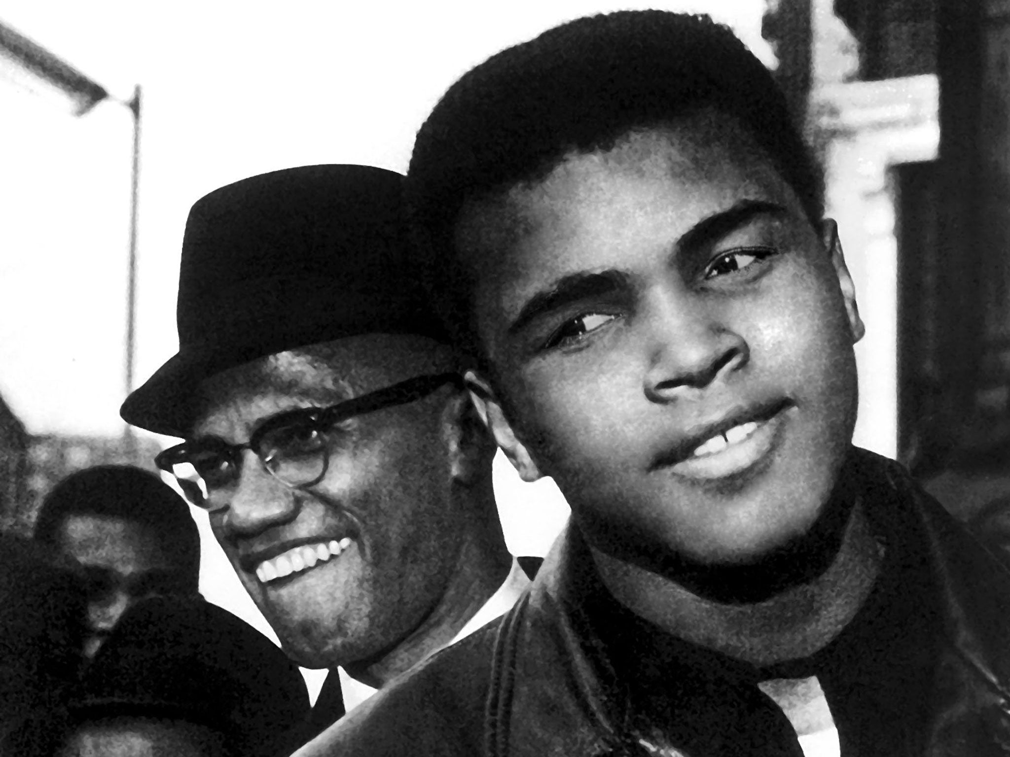 Muhammad Ali with friend Malcolm X, walking in Harlem, New York, 1972