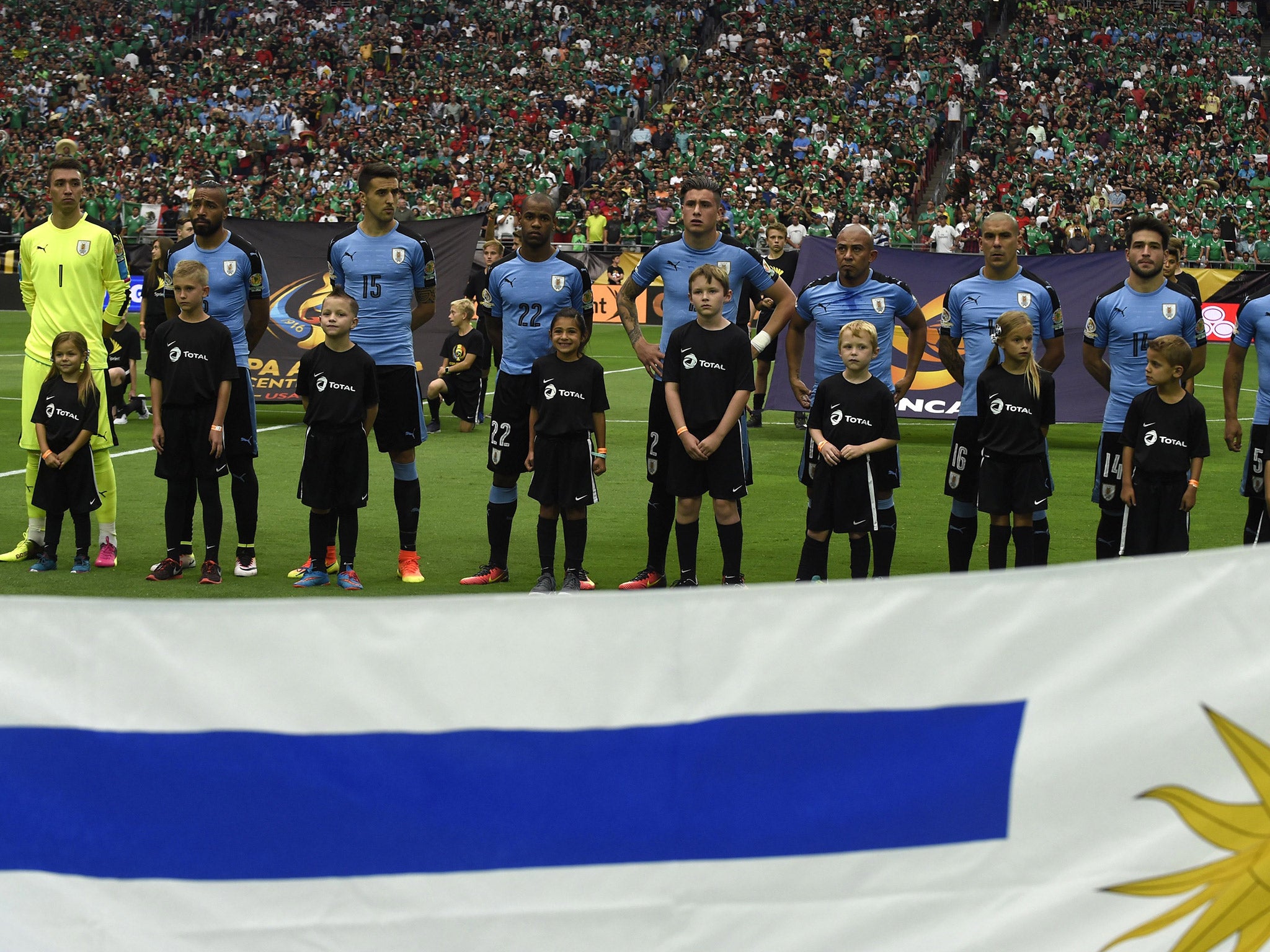 Uruguay players line up for the national anthems