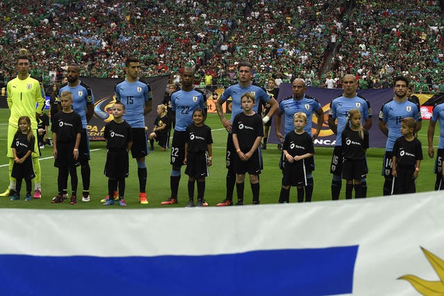 Uruguay players line up for the national anthems