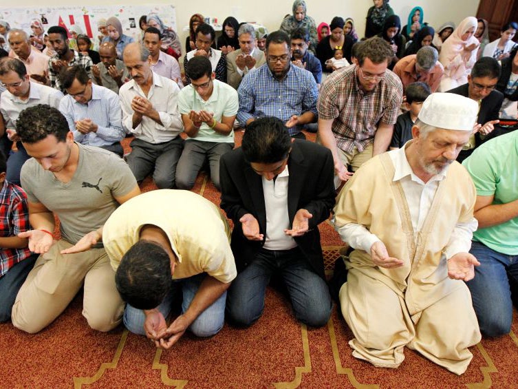 Members of the Louisville Islamic Center pray together before an inter-faith service to honor Muhammad Ali