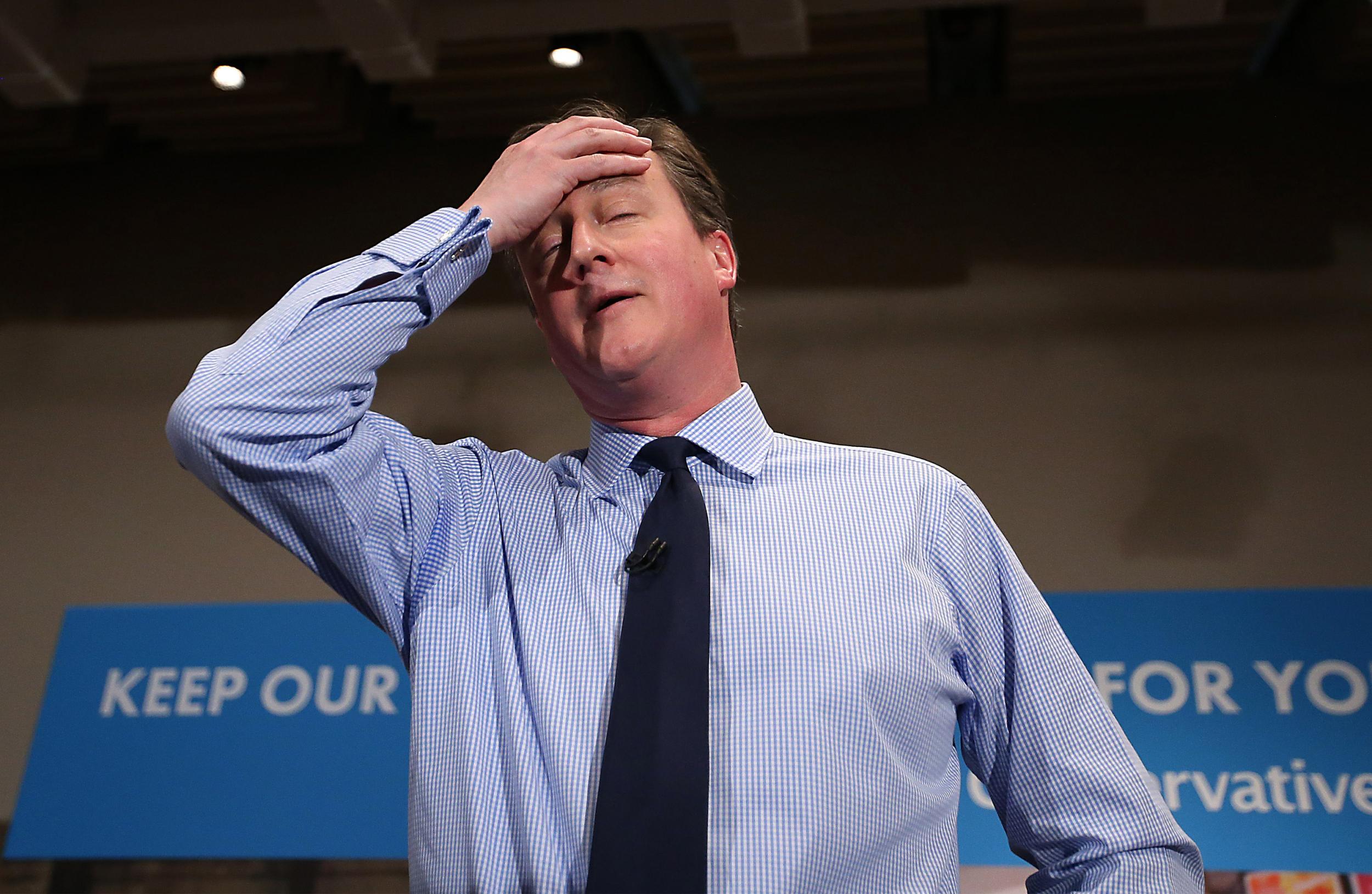 Prime Minister David Cameron wipes his brow