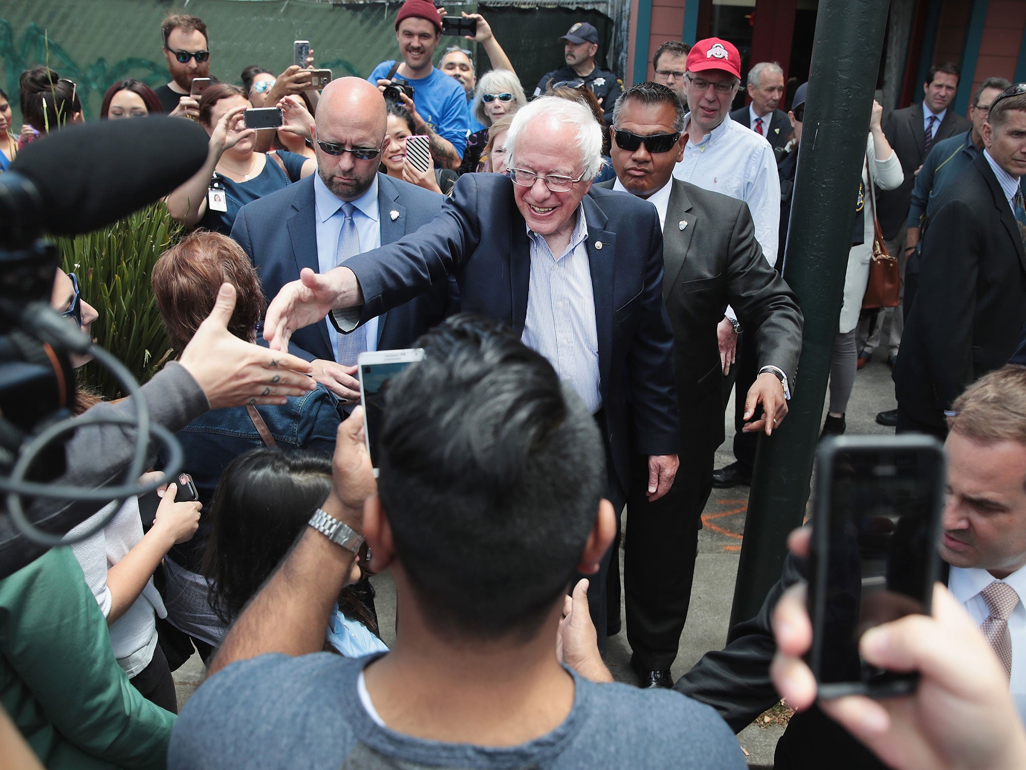 Sanders greets people outside Aunt Mary's Cafe in Oakland