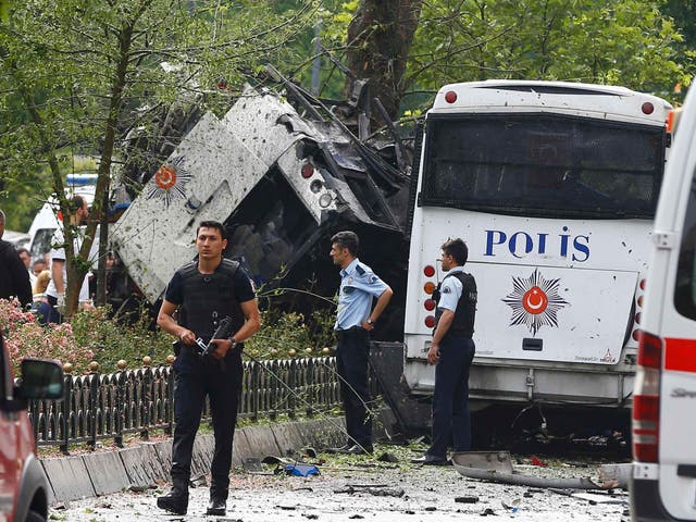 Police walk near a Turkish police bus which was targeted in a bomb attack in a central Istanbul district, Turkey, June 7, 2016.