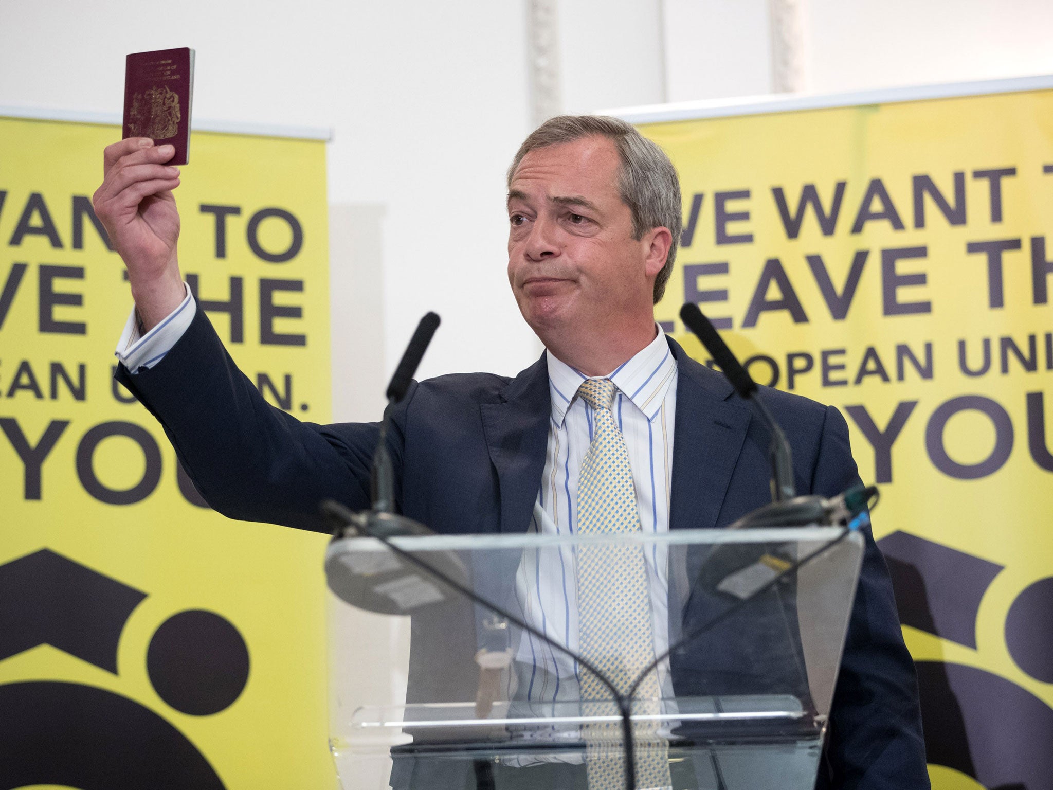Ukip leader Nigel Farage holds up his British passport as he speaks at a Grassroots Out! campaign rally in Bristol