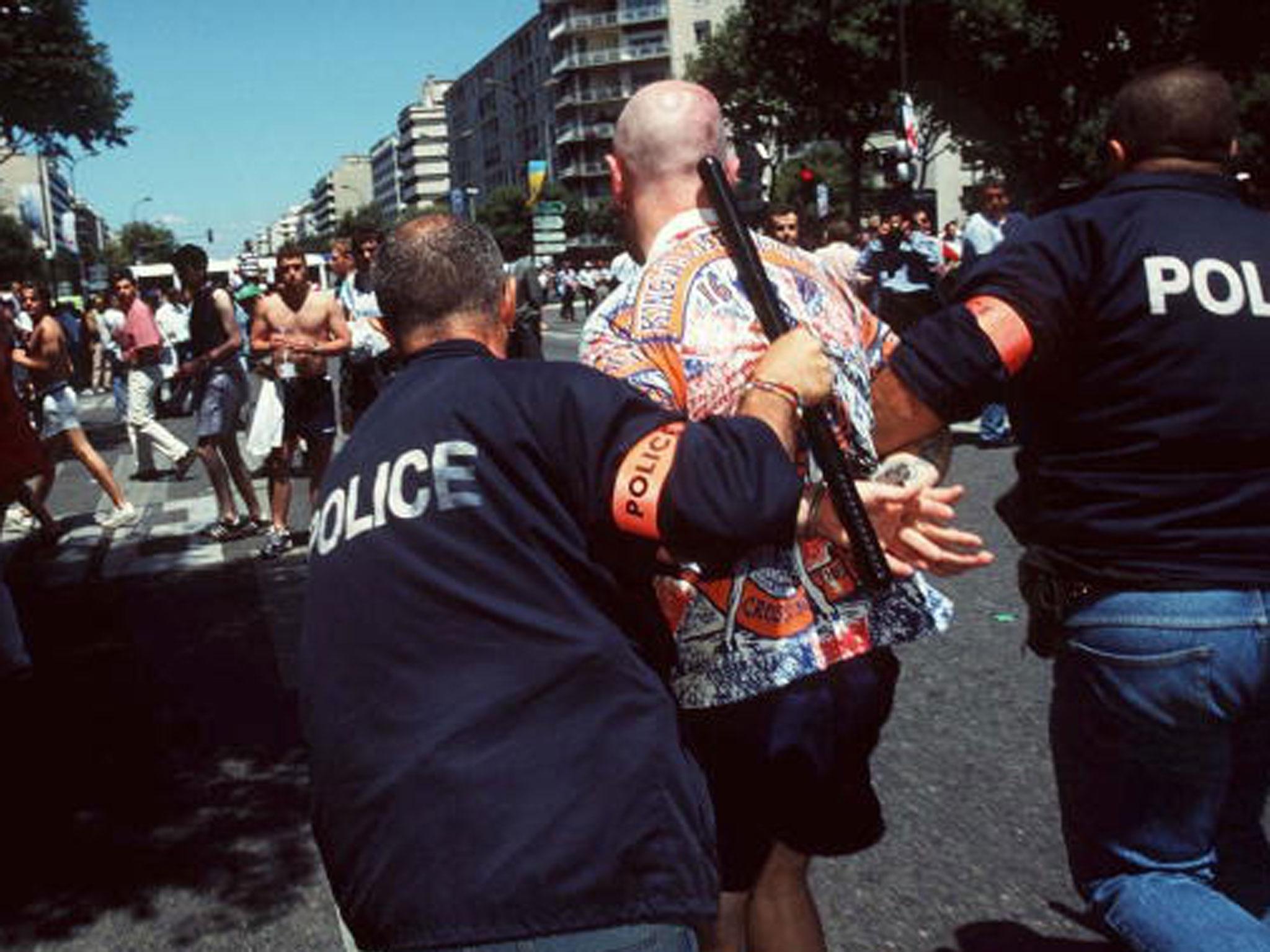 &#13;
An England supporter is led away by French police after clashes in Marseilles during the 1998 World Cup finals (Getty)&#13;