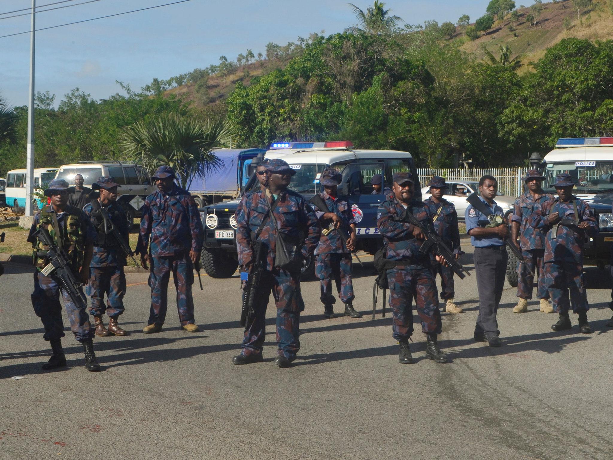 Heavily-armed Papua New Guinea police form a roadblock, preventing students from leaving the University of Papua New Guinea