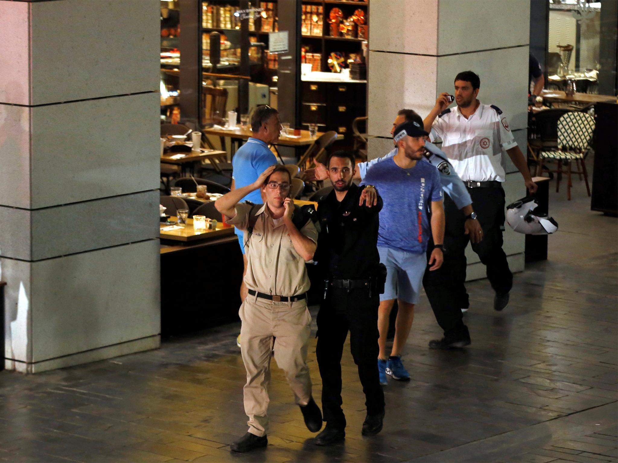 Police clear the scene after a shooting took place in central Tel Aviv.