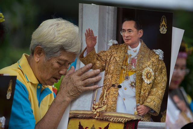A Thai woman prays for ailing King Bhumibol Adulyadej at Siriraj hospital, Bangkok