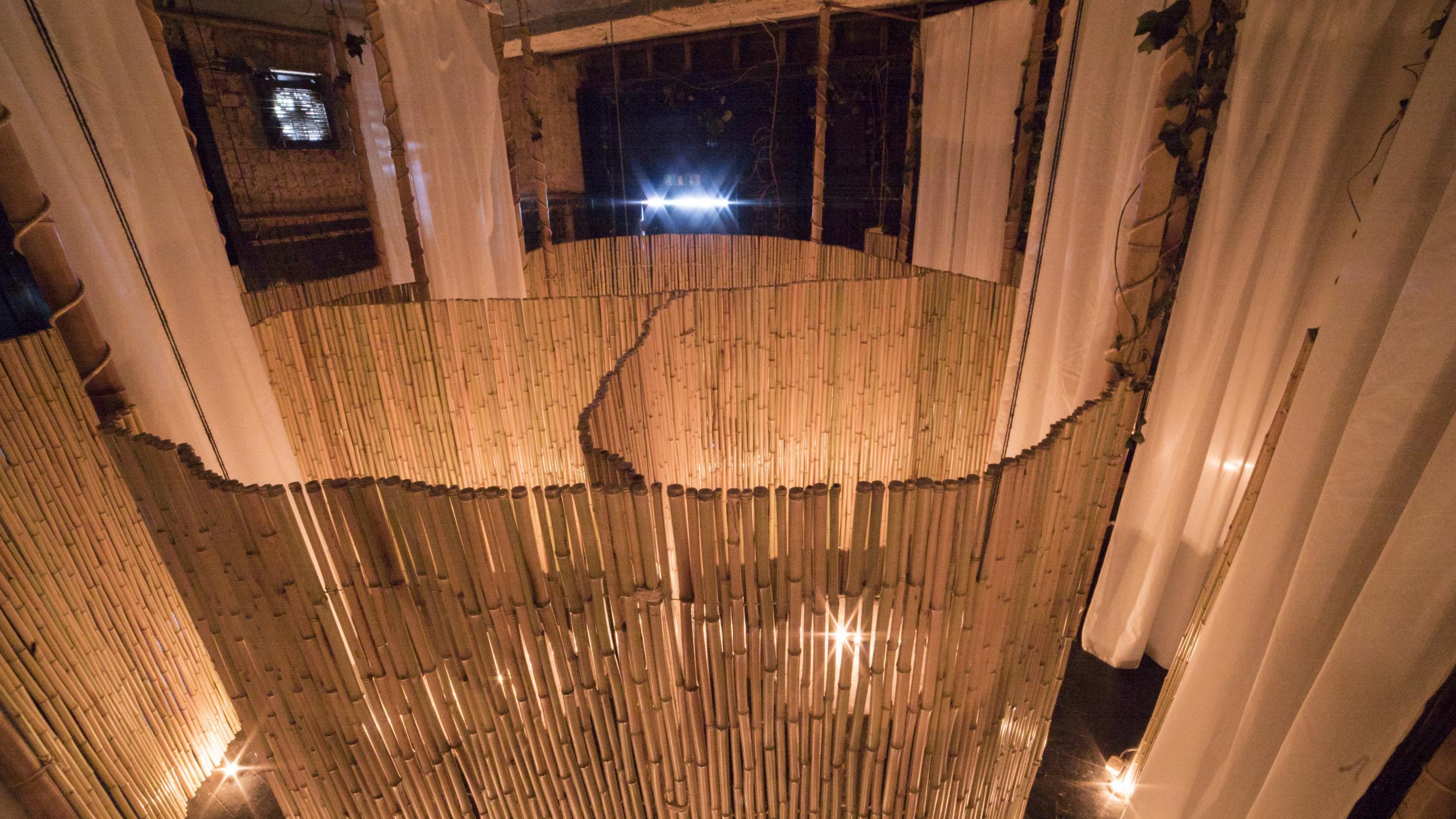 Bamboo booths separate the naked diners