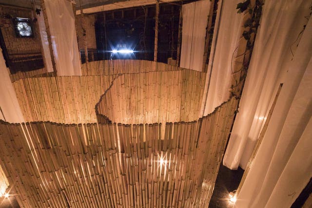 Bamboo booths separate the naked diners