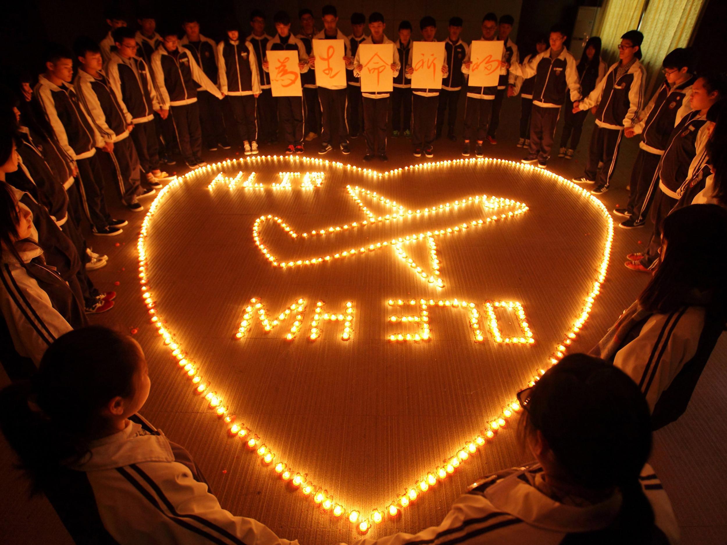 Students at Hailiang International School in Zhuji, China light candles for the passengers on the Malaysia Airlines MH370 flight, just a few days after the aircraft went missing in 2014