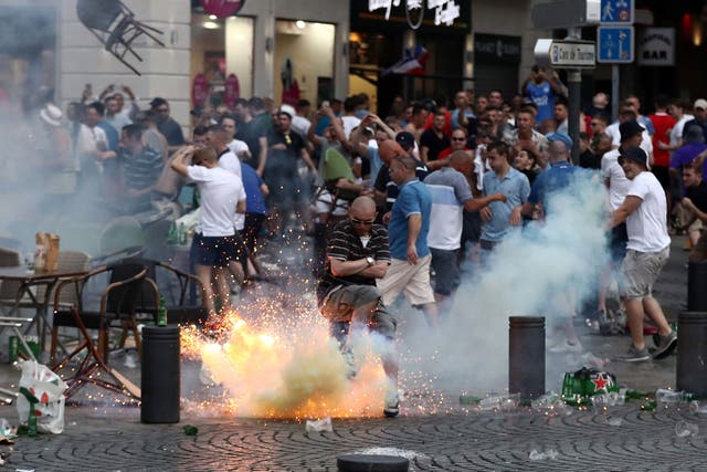 A tear gas canister explodes under a football fan as England fans clash with police in Marseille