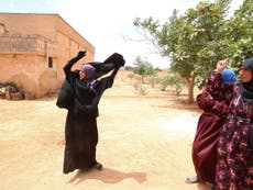 Syrian women pictured throwing off niqabs after their village was freed from Isis 
