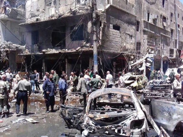 Syrians gathering at the scene of a double bomb attack outside the Sayyida Zeinab shrine