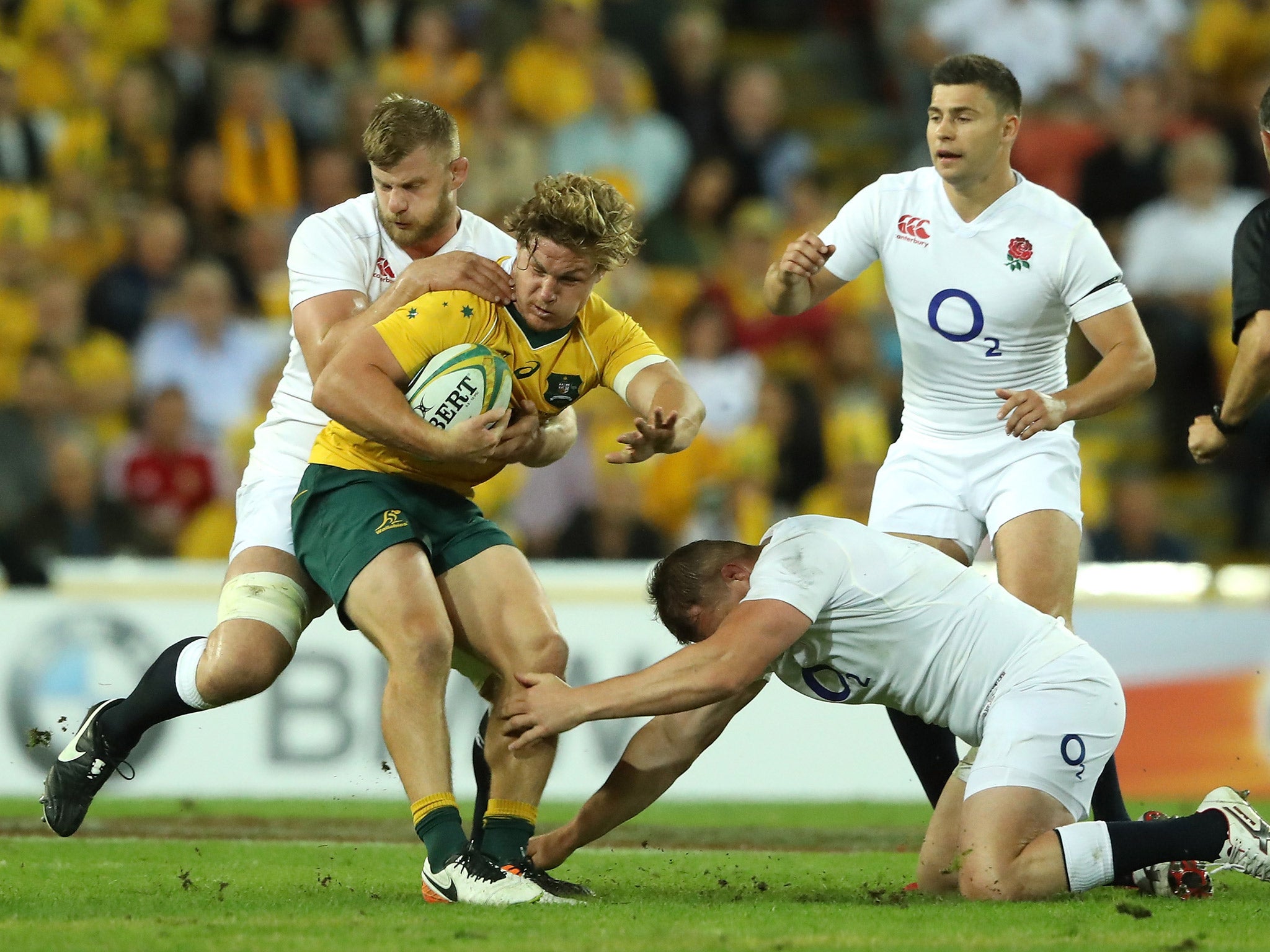 Michael Hooper is tackled by George Kruis