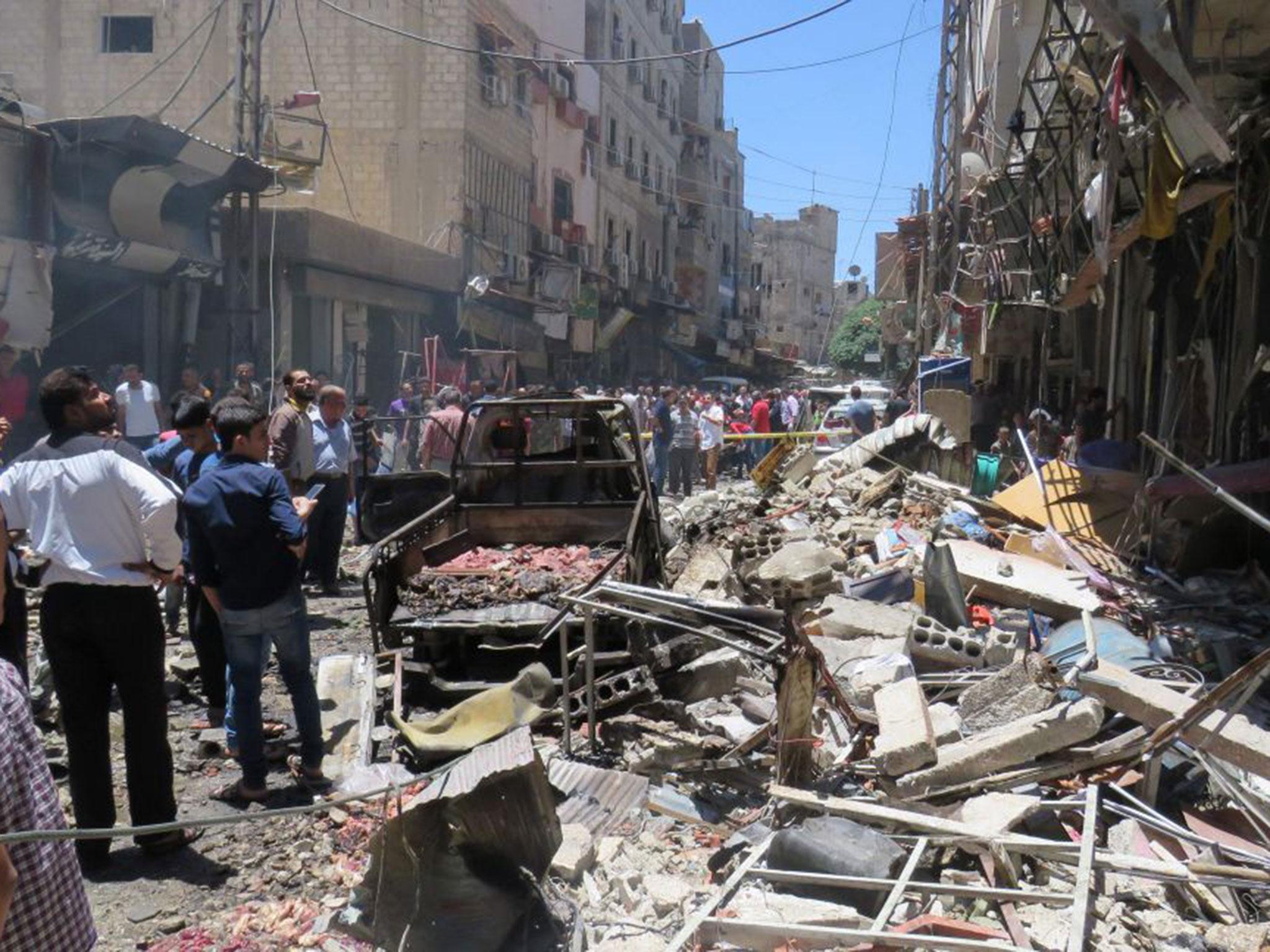 Syrians gathering at the scene of a double bomb attack outside the Sayyida Zeinab shrine