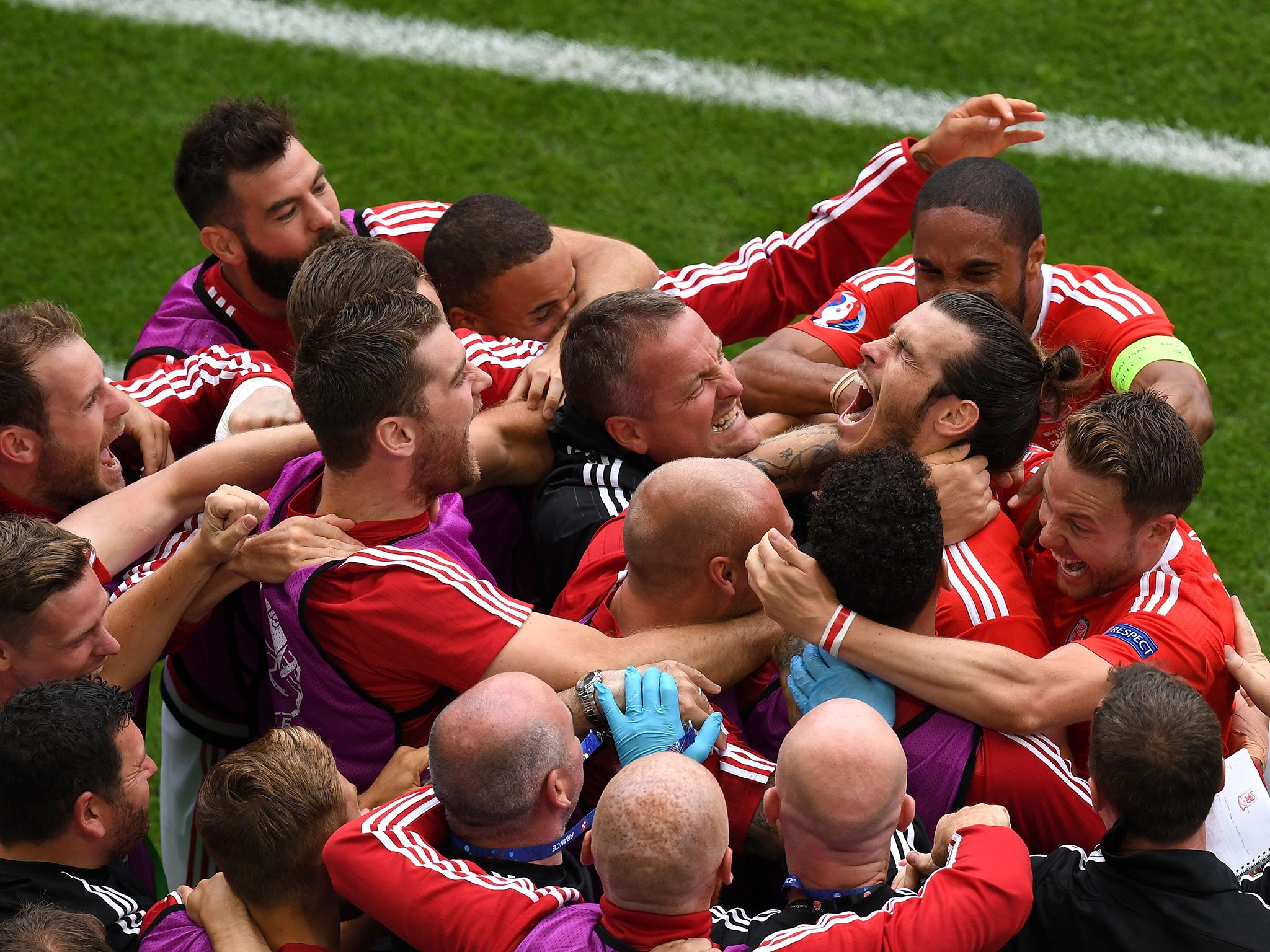 Gareth Bale celebrates with the Wales bench after scoring against Slovakia