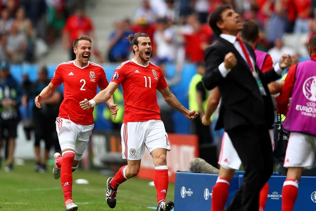 Gareth Bale sprints to his team-mates as Chris Coleman celebrates Wales taking the lead