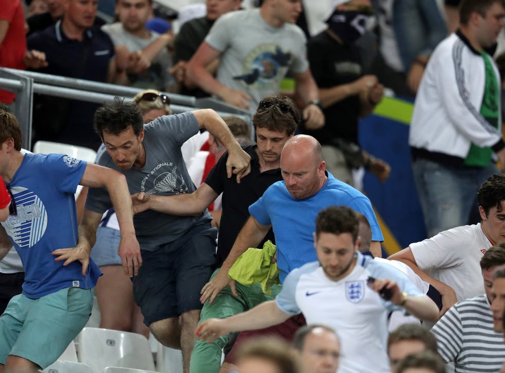 England fans flee to safety after they were charged at by Russian supporters