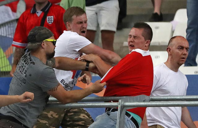 Russian supporters attack an England fan at the end of the match at the Velodrome stadium