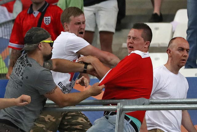 Russian supporters attack an England fan at the end of the match at the Velodrome stadium