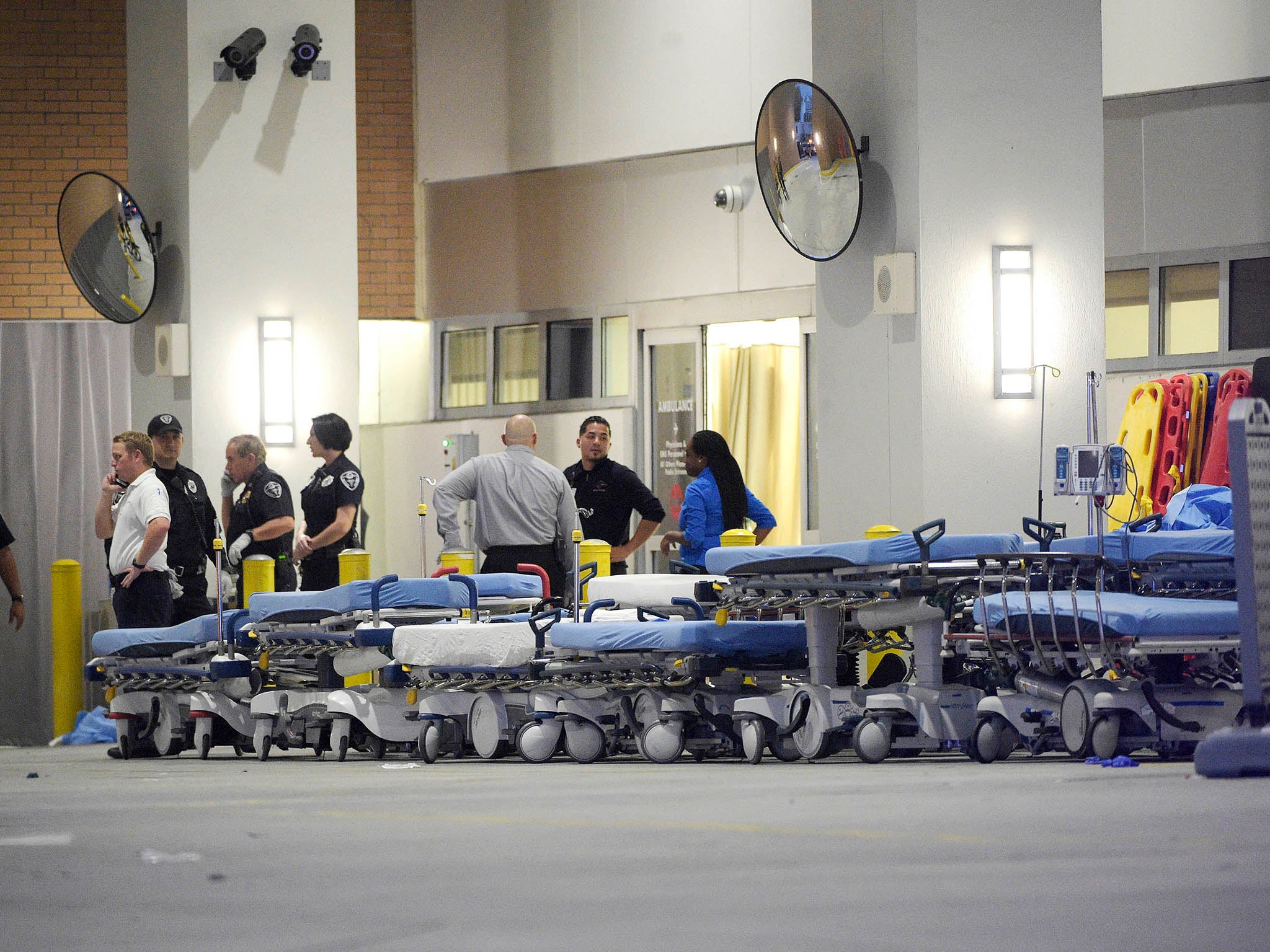 Medics wait with stretchers at the emergency entrance to Orlando Regional Medical Center hospital