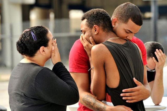 Friends and family console one another outside the Orlando Police Headquarters