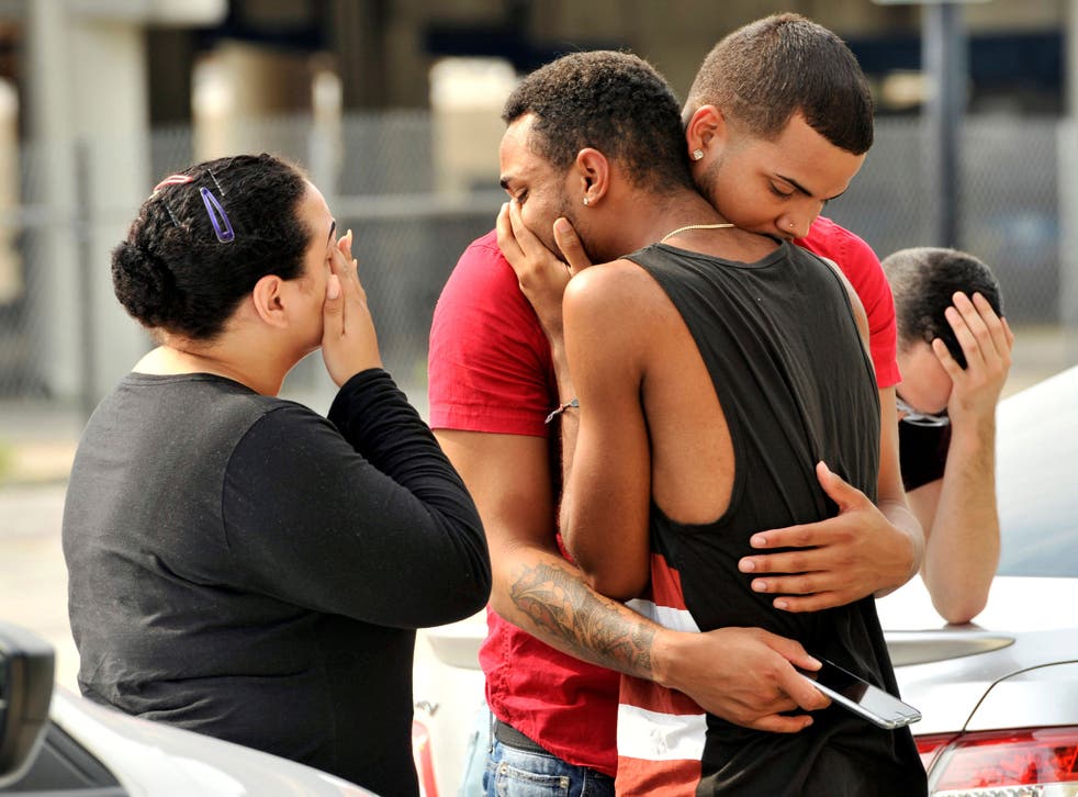 Orlando Police officers direct family members away from the scene of the shooting