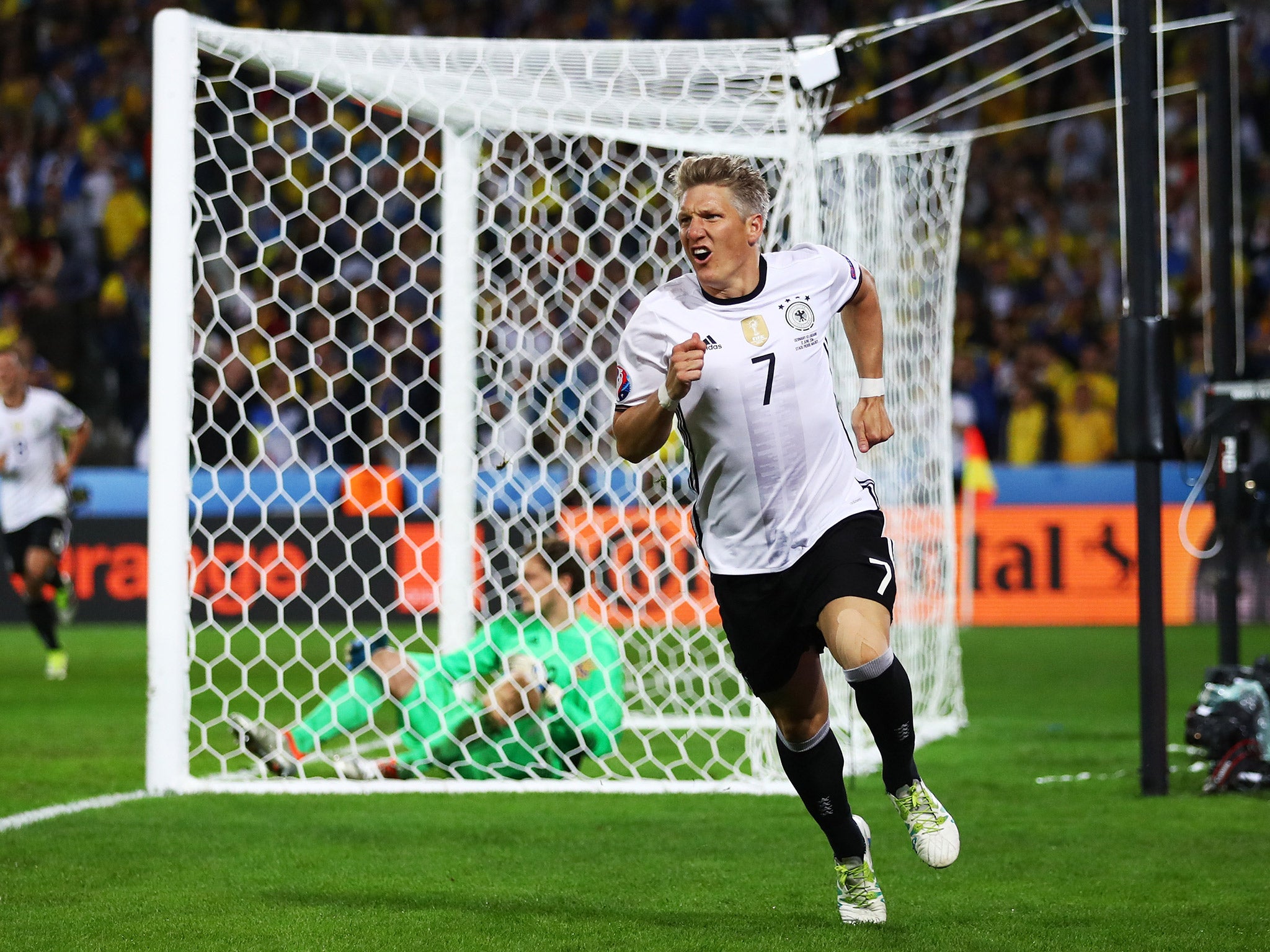 Bastian Schweinsteiger peels away after scoring Germany's second goal against Ukraine